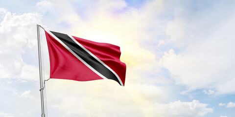 Trinidad and Tobago flag waving on sky background. 3D Rendering