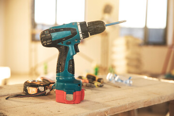 electric drill on a wooden table with