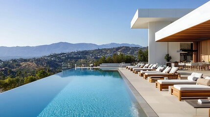 A sleek, modern infinity pool overlooking stunning mountain views, surrounded by comfortable lounge chairs and a stylish outdoor seating area, offering a luxurious retreat.