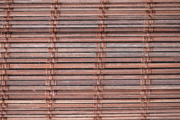 Background texture showing horizontal bamboo slats with string