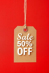 Sale tag with discount 50% on red background, perfect for marketing promotions, holiday sales, and retail advertising campaigns, space for text