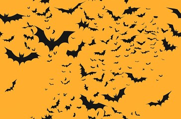 Orange background black bat silhouettes flying in the sky