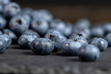 a pile of blueberries scattered on the board