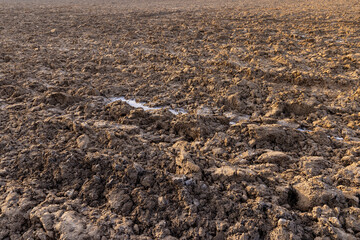 plowed fertile soil of the field in winter