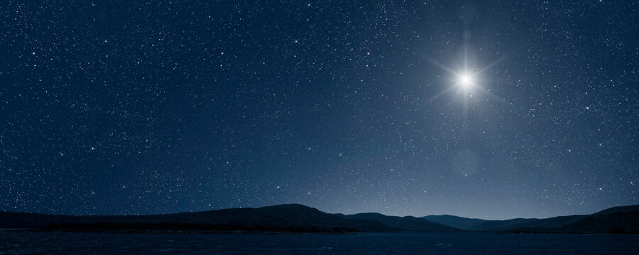 a Christmas star shines at night over the mountains of Bethlehem