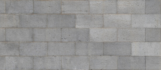 Panoramic background of a wall with gray stone blocks, featuring a smooth and uniform texture