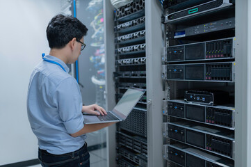 Computer engineer is setting up network in server room,Systems Maintenance Technician,Male engineer...