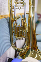 A trumpet on a bench in a brass band.