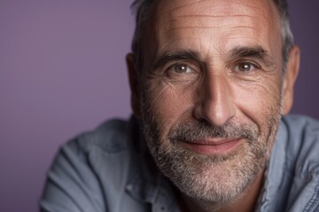 Fototapeta premium Middle-Aged Man with Confident Smile on Lavender Background for Portrait and Design