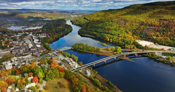 Beautiful river flowing through the landscape of Vermont, New England, USA. Autumn scenery of the city from top.