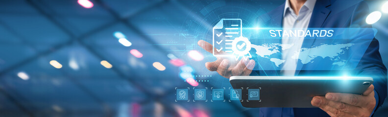 Standards. Businessman using tablet analyzing business performance standards, industry compliance regulations, market trend analysis, financial forecasting metrics, customer satisfaction criteria.