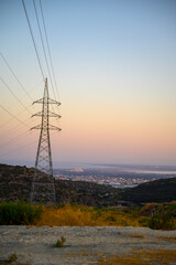 This is a shot of a high-voltage electric transmission tower, also known as an electricity overhead...