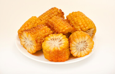 Fried corn on a white background. Delicious corn. Delicious toasted corn cobs.