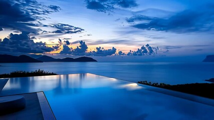 Serene sunset view from a luxury villa with an infinity pool overlooking the ocean.