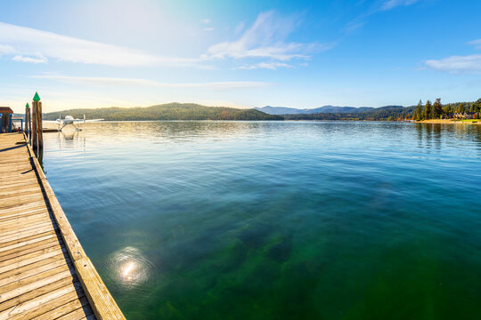 A seaplane is docked at Independence Point with the city beach and park at Fort Grounds in view, on the lake in Coeur d'Alene, Idaho USA at Autumn.