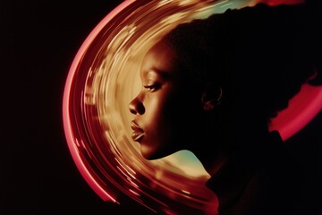 A woman's face is shown in a blurry, distorted way. The image is in black and white and has a surreal, dreamlike quality to it. The woman's face is the main focus of the image