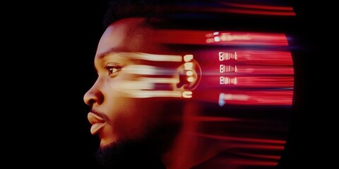 A man's face is blurred in a red light. The man's face is the main focus of the image