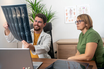 Health consultant explaining diagnosis to woman patient in clinic office medium shot. Doctor...