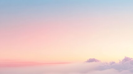 Fototapeta premium A serene sky at dawn with soft pastel colors blending from blue to pink, creating a peaceful and calming atmosphere.
