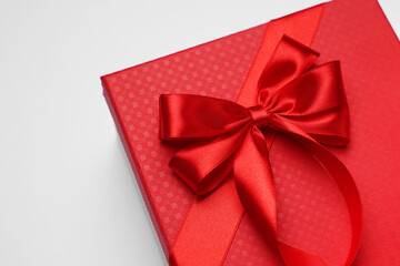 Gift box with bow on light grey background
