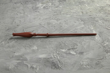 One magic wand on grey textured table