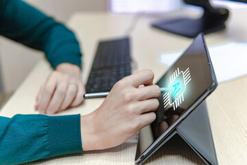 Side view of a business man using a tablet in the office with a pen, artificial inteligence icon in the screen, online work concept