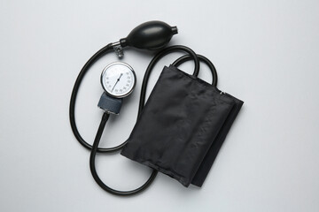Blood pressure measuring device on light grey background, top view