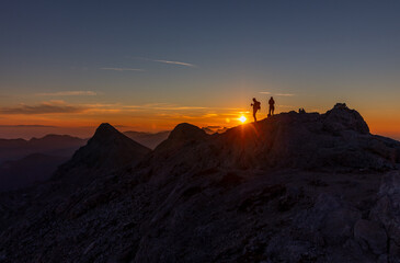 two people during sunrise in the alps of  Slovenian Alps Julian against sun good lightwarm light landscape golden hour golden light