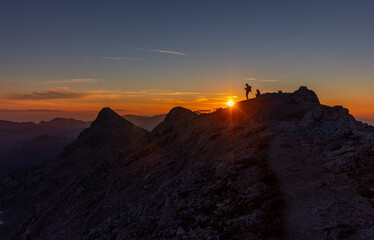 two people during sunrise in the alps of  Slovenian Alps Julian against sun good lightwarm light landscape golden hour golden light