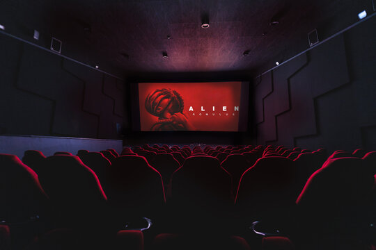 Alien: Romulus action horror movie on empty Cinema theatre, big projection screen showing popular movie