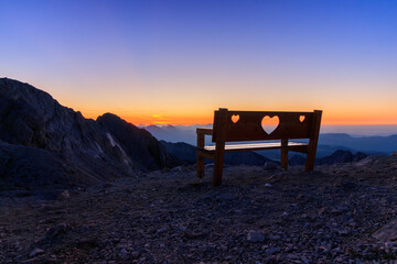 Bench in the mountains of Slovenian Alps Julian Alps during sunrise and blue hour