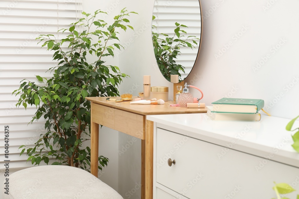 Wall mural Mirror, dressing table, houseplant and chest of drawers indoors. Interior design