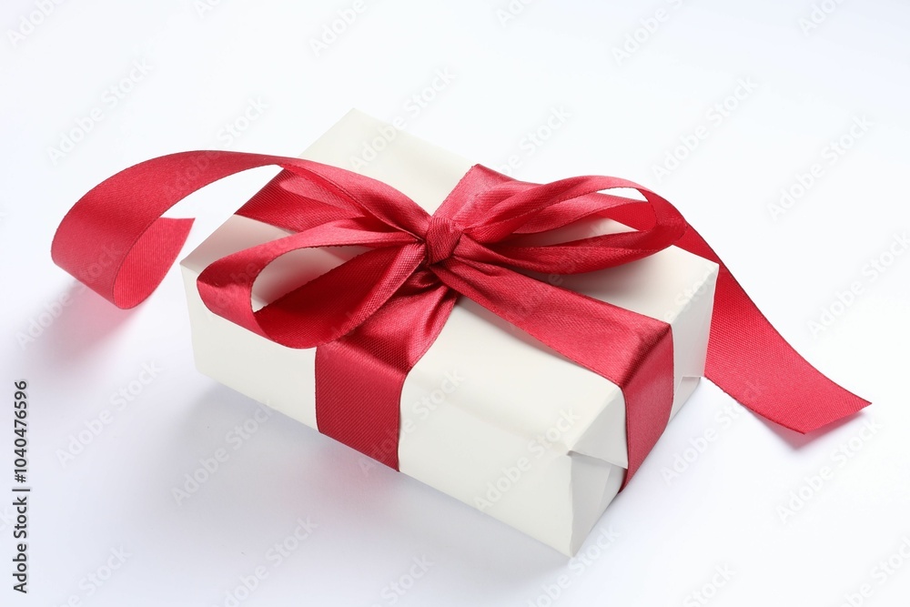 Poster Beautiful gift box with red bow isolated on white