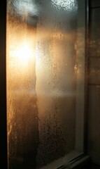 Obraz premium Sunset through a foggy window pane.