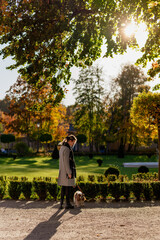 Woman in a park with cute dog