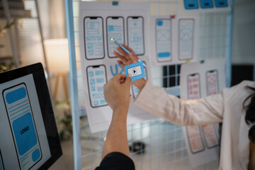 Uiux designers reviewing mobile application interface design during a brainstorming session