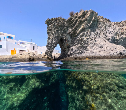 Underwater split photo of famous elephant rock in picturesque Goupa seaside area with crystal clear sea in island of Kimolos, Cyclades, Greece