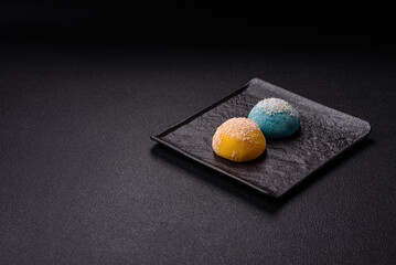 Delicious colorful asian mochi sweets with rice dough shell and fruit filling