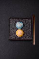 Delicious colorful asian mochi sweets with rice dough shell and fruit filling