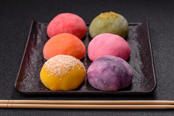 Delicious colorful asian mochi sweets with rice dough shell and fruit filling