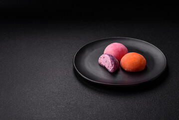 Delicious colorful asian mochi sweets with rice dough shell and fruit filling