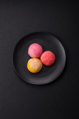 Delicious colorful asian mochi sweets with rice dough shell and fruit filling