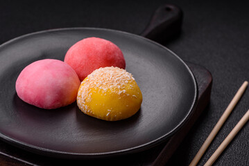 Delicious colorful asian mochi sweets with rice dough shell and fruit filling