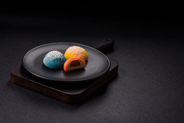 Delicious colorful asian mochi sweets with rice dough shell and fruit filling