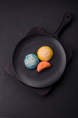 Delicious colorful asian mochi sweets with rice dough shell and fruit filling