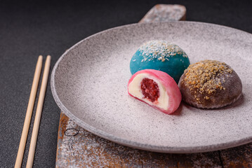 Delicious colorful asian mochi sweets with rice dough shell and fruit filling