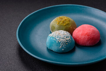 Delicious colorful asian mochi sweets with rice dough shell and fruit filling