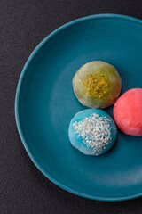 Delicious colorful asian mochi sweets with rice dough shell and fruit filling