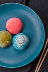 Delicious colorful asian mochi sweets with rice dough shell and fruit filling