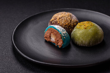Delicious colorful asian mochi sweets with rice dough shell and fruit filling